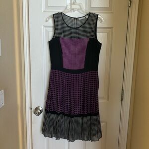 Fun twirly dress with black lining and one button closure in back and side zip.